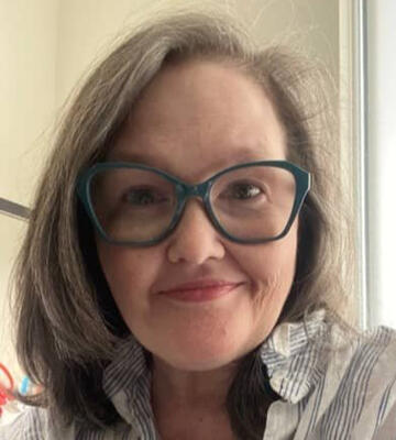 Headshot of Rachel wearing glasses